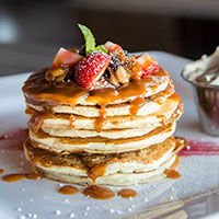 Pancakes with caramel and fresh strawberries